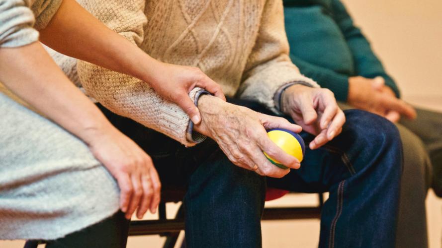Older persons holding a stress ball