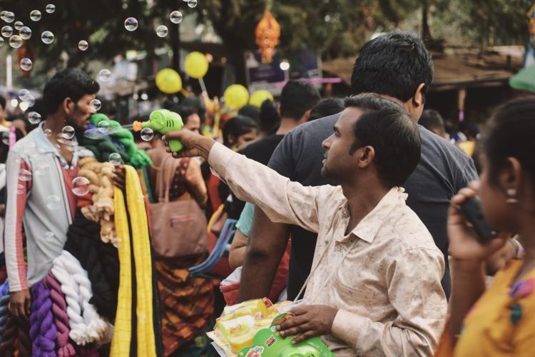 A man selling bubbles somewhere in India.